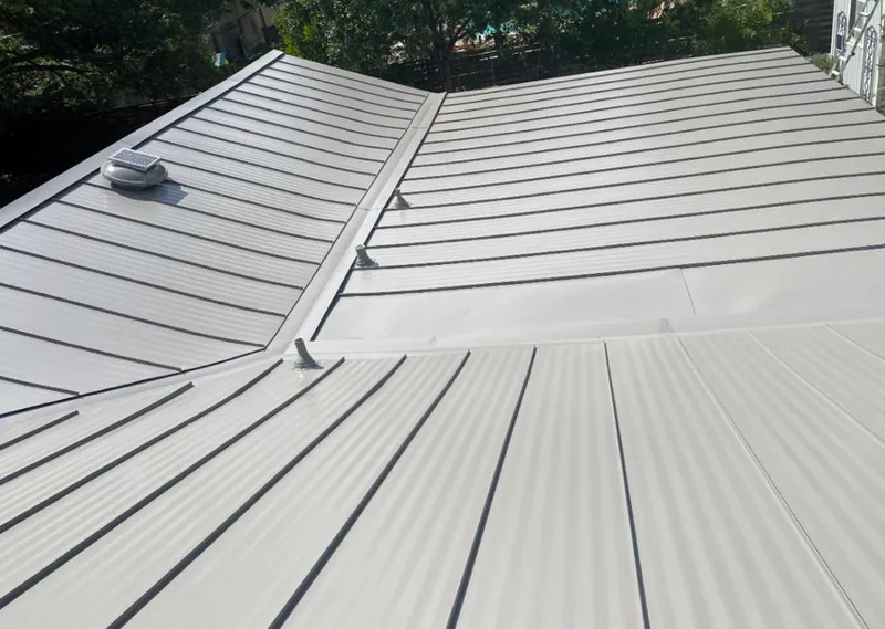 Solar attic fan installed on a metal roof for Roof Ventilation in Albany